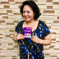 Woman and gift card brick wall paul powell