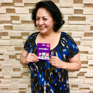 A woman holding a Babies'R'Us gift card, symbolizing the impact of a child's injury and the support a Las Vegas personal injury law firm can provide to families.