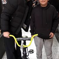 Paul Powell and kid with bike Day of Kings