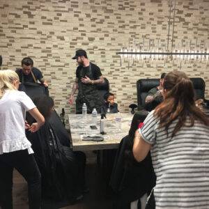 Image shows a busy hair salon with multiple stylists and clients, suggesting a bustling environment where personal injuries might occur, emphasizing the need for a Las Vegas personal injury lawyer.