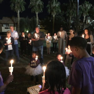 Group of people in Las Vegas holding candles in memory of personal injury victims, demonstrating community support and solidarity.