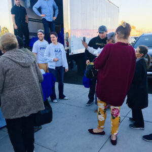 Law firm representatives distribute materials from a truck to community members, highlighting their commitment to helping injury victims in Las Vegas.