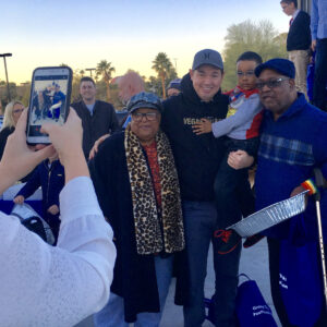 A Las Vegas personal injury law firm's representative poses for a photo with community members at a local event, showing their commitment to serving and supporting the community.