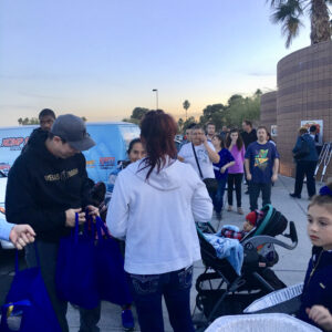 A Las Vegas personal injury law firm hosts an event, distributing bags and refreshments to families in the community, demonstrating their commitment to supporting those in need after an accident or injury.