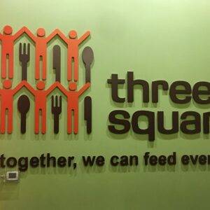 A photo of the "Three Square" logo, a Las Vegas food bank, symbolizing the law firm's dedication to serving the community and seeking justice for personal injury victims, with a Christmas tree suggesting a focus on support during the holiday season.
