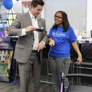 Las Vegas personal injury attorney interacts with a Make-A-Wish recipient, highlighting the firm's commitment to community support and those recovering from injuries.