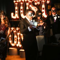 Speaker with microphone at masquerade ball