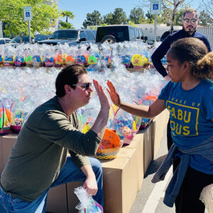 A Las Vegas law firm is pictured supporting the community by distributing hundreds of Easter baskets to children in need, emphasizing the firm's commitment to helping those impacted by personal injury.