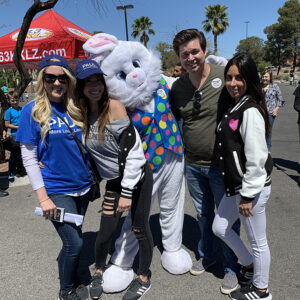 Personal injury lawyers at a Las Vegas community event with an Easter bunny mascot and attendees, promoting legal services and community engagement.