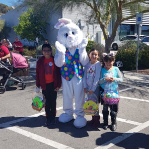 A photo depicting children posing with the Easter Bunny at a community event, highlighting the law firm's involvement in family-friendly activities and community support in Las Vegas, with a focus on personal injury concerns during holiday events.