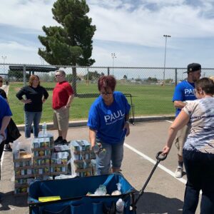 Law firm volunteers stack and load canned goods for a charitable cause in Las Vegas.