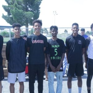 A group of young athletes, potentially injured, stand together outdoors, representing the community support provided by a Las Vegas personal injury law firm dedicated to helping young athletes recover after accidents and get back in the game.
