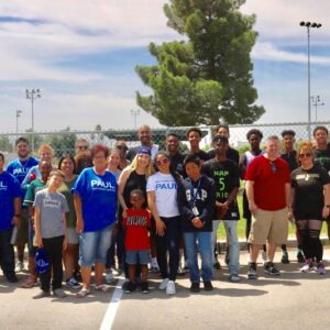 Group photo of volunteers and community members at an outdoor event in Las Vegas, representing a personal injury law firm.