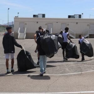 Las Vegas personal injury law firm supports community clean-up, showing commitment to safety and well-being by having people pick up trash with trash bags.