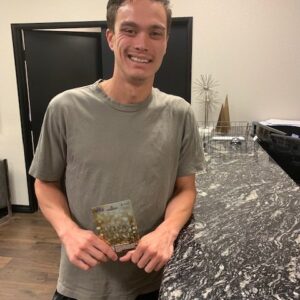 A happy client of a Las Vegas personal injury law firm holds a settlement check, symbolizing successful case resolution and financial recovery after an accident.