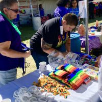 women attending pride festival table