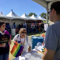 Paul Powell at merch table pride festival