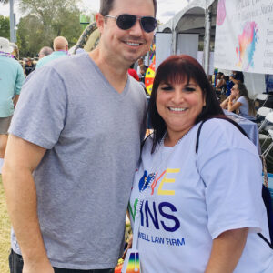 A photo of a smiling man and woman representing Paul & Perkins Personal Injury Law Firm at a community event in Las Vegas.