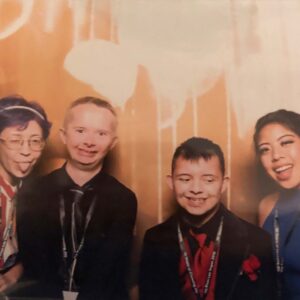 Smiling group of diverse people in Las Vegas, possibly attending a community event or celebration, with a positive and inclusive atmosphere, reflecting values that a personal injury law firm may emphasize.