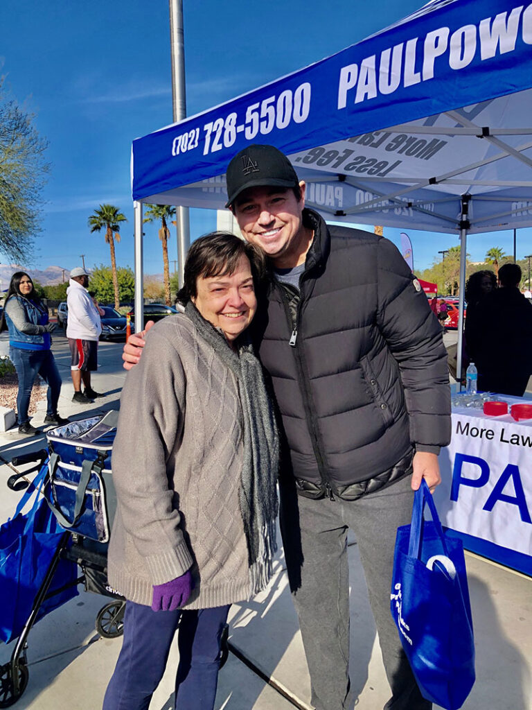 Personal injury lawyer poses with a client at a Las Vegas community event, showcasing the law firm's engagement and dedication to helping individuals in need of legal representation after an accident.