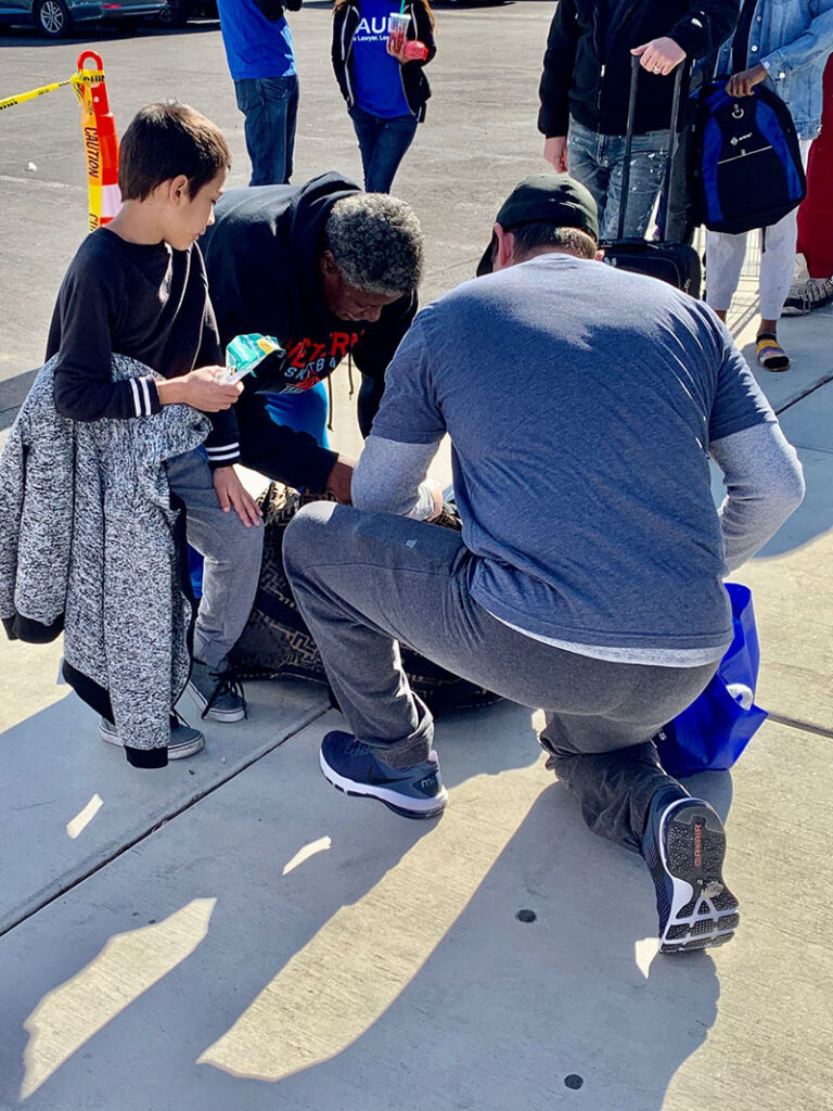 Las Vegas personal injury lawyers helping a family, showing compassion and support, assisting with belongings after an accident.