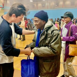 Image shows a Las Vegas lawyer greeting a senior citizen at a community event, showing compassion and support for personal injury victims.