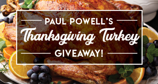 Close up of a delicious Thanksgiving turkey surrounded by fruit, with a banner advertising a giveaway from the Paul Powell law firm, highlighting their community involvement and services related to personal injury in Las Vegas.