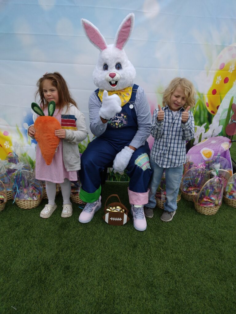 Easter bunny with two children and gift baskets in Las Vegas, promoting safety and legal protection for families.