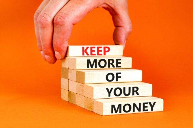 A hand placing a block labeled "KEEP" atop a stack of blocks that read "MORE OF YOUR MONEY," symbolizing how a personal injury law firm can help clients retain a larger portion of their settlement after an accident in Las Vegas.