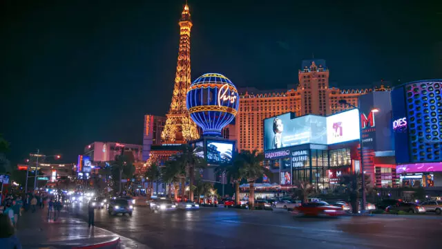 Night view of the Las Vegas Strip with illuminated casinos, hotels, traffic, and pedestrians, representing the city's vibrant and potentially hazardous environment where personal injury accidents can occur.
