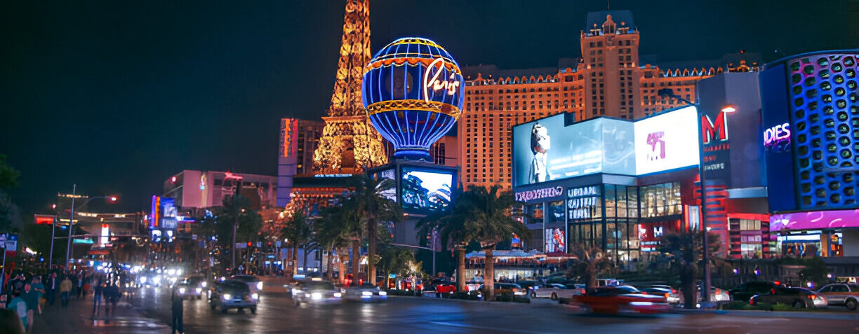 Night view of the Las Vegas Strip with illuminated casinos, hotels, traffic, and pedestrians, representing the city's vibrant and potentially hazardous environment where personal injury accidents can occur.